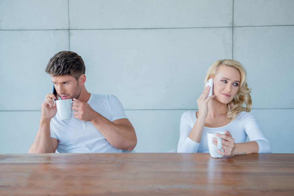 http://www.dreamstime.com/stock-photography-couple-both-using-their-mobile-phones-simultaneously-as-sit-wooden-counter-enjoying-morning-coffee-image45025012